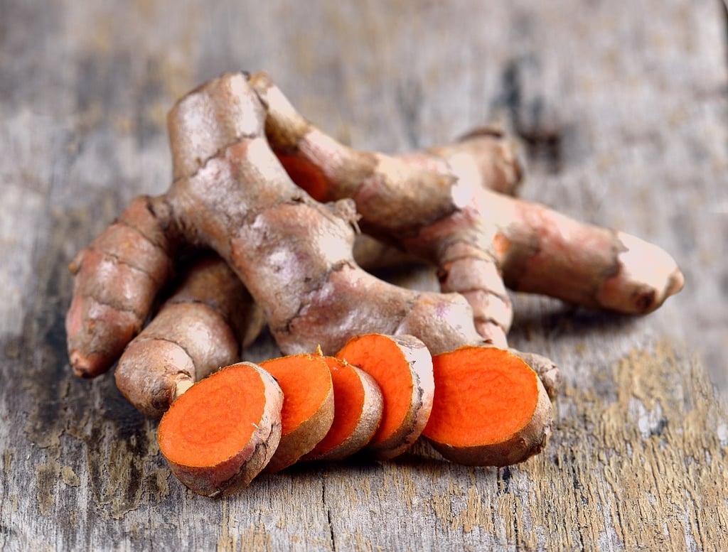 Turmeric looks like ginger on the outside, but inside the flesh is vivid yellow-orange. Photo: Shutterstock Turmeric looks like ginger on the outside, but inside the flesh is vivid yellow-orange. Photo: Shutterstock