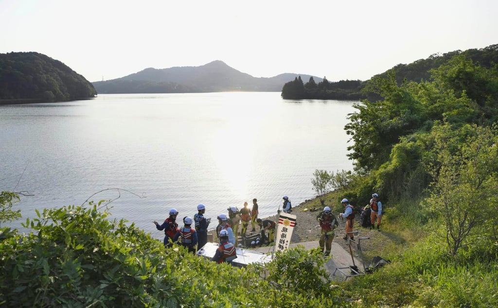 Firefighters gather in Inuyama, central Japan, for a search operation as a Japanese air force plane crashed after taking off for a training flight. Photo: via AP Firefighters gather in Inuyama, central Japan, for a search operation as a Japanese air force plane crashed after taking off for a training flight. Photo: via AP