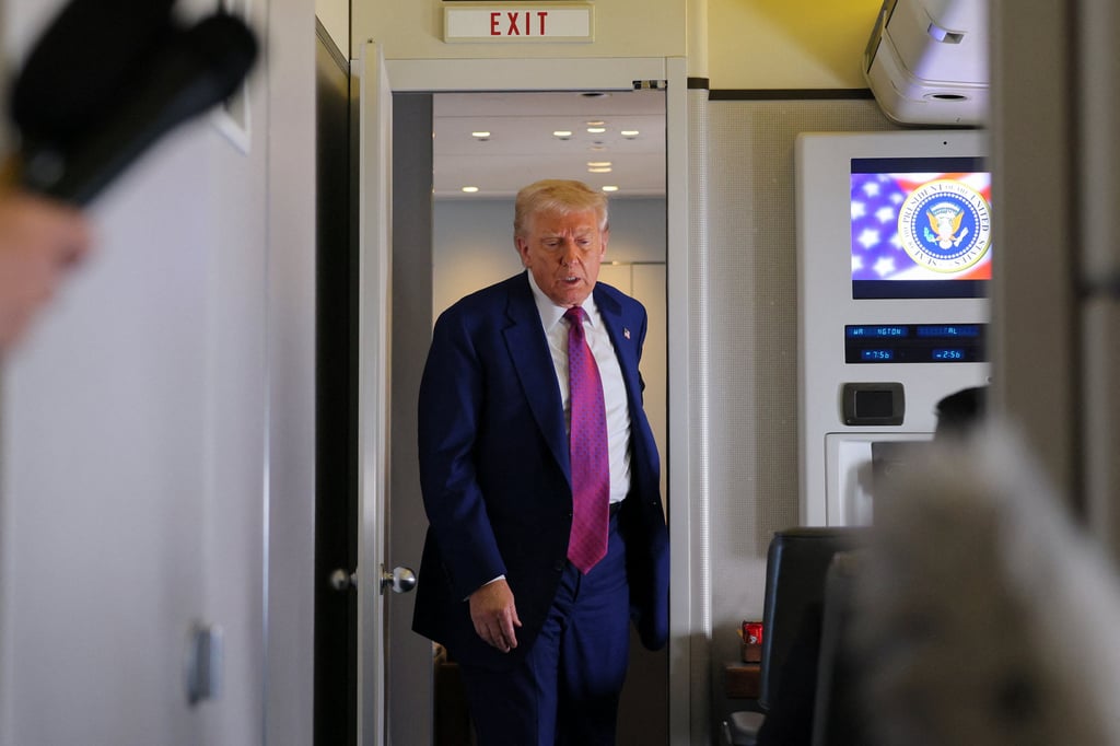 US President Donald Trump emerges to talk to reporters aboard Air Force One, en-route to Abu Dhabi, on Thursday. Photo: Reuters
