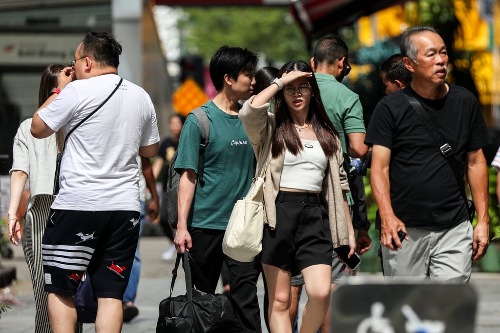 People walk along a street in Kuala Lumpur, Malaysia. Photo: EPA-EFE People walk along a street in Kuala Lumpur, Malaysia. Photo: EPA-EFE