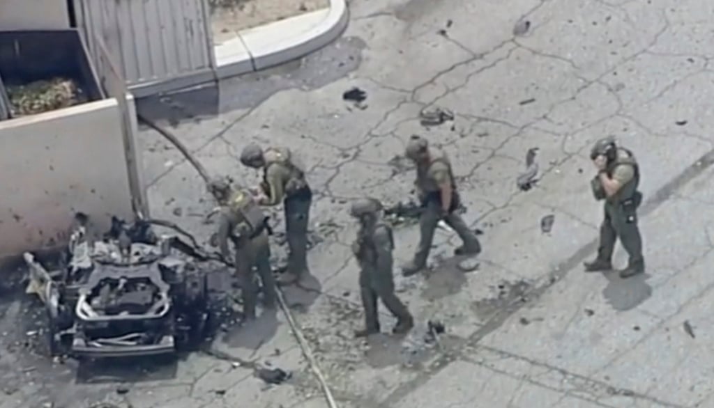 Law enforcement officers investigate a vehicle after an explosion in Palm Springs, California, on Saturday. Photo: ABC7 Los Angeles via AP