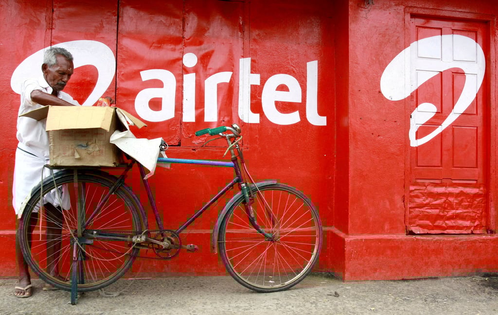 A man packs goods on the back of his bicycle next to an advertisement for Bharti Airtel in the southern Indian city of Kochi, in 2011. Photo: Reuters A man packs goods on the back of his bicycle next to an advertisement for Bharti Airtel in the southern Indian city of Kochi, in 2011. Photo: Reuters