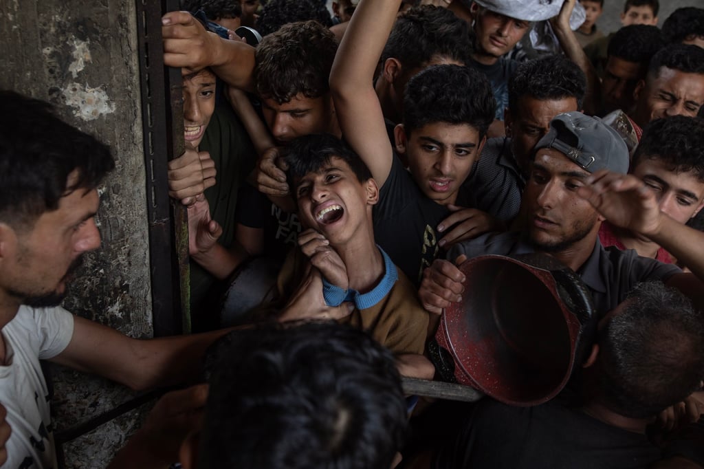 Hundreds of internally displaced Palestinians gather outside a charity kitchen in Gaza City to receive limited food rations on Sunday. Photo: EPA-EFE Hundreds of internally displaced Palestinians gather outside a charity kitchen in Gaza City to receive limited food rations on Sunday. Photo: EPA-EFE