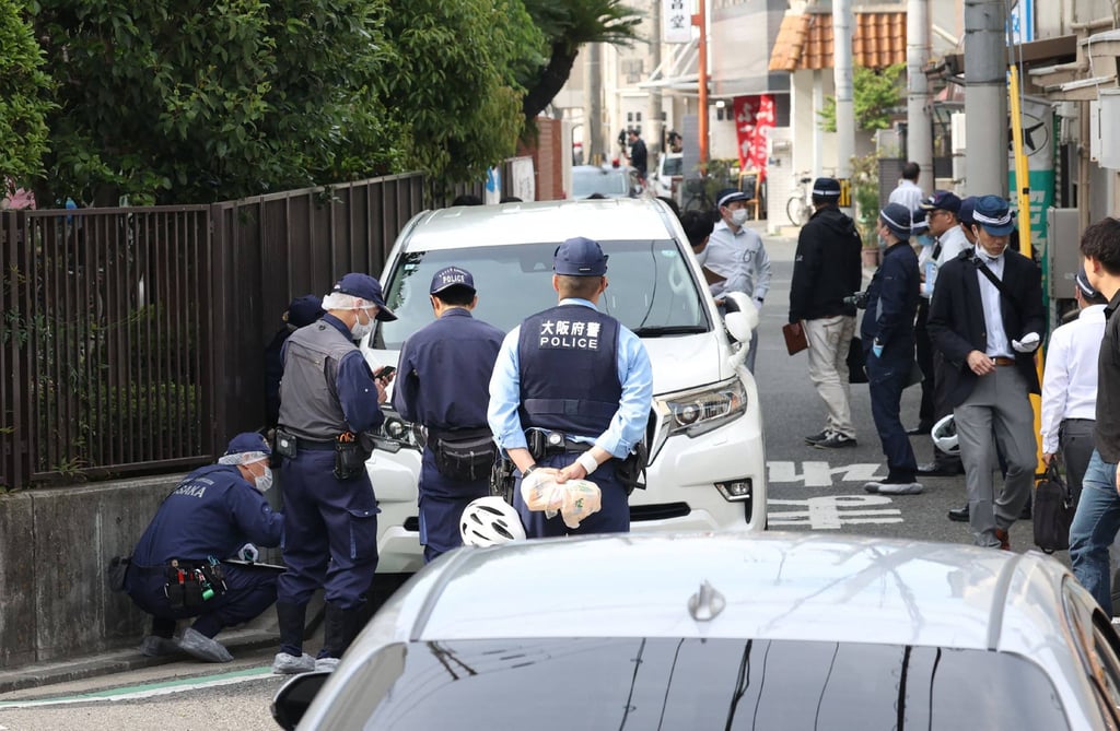 Police officers investigate the scene in Osaka’s Nishinari district on May 1, after a man ploughed his car into seven schoolchildren in a suspected deliberate attack. Photo: Jiji Press / AFP Police officers investigate the scene in Osaka’s Nishinari district on May 1, after a man ploughed his car into seven schoolchildren in a suspected deliberate attack. Photo: Jiji Press / AFP