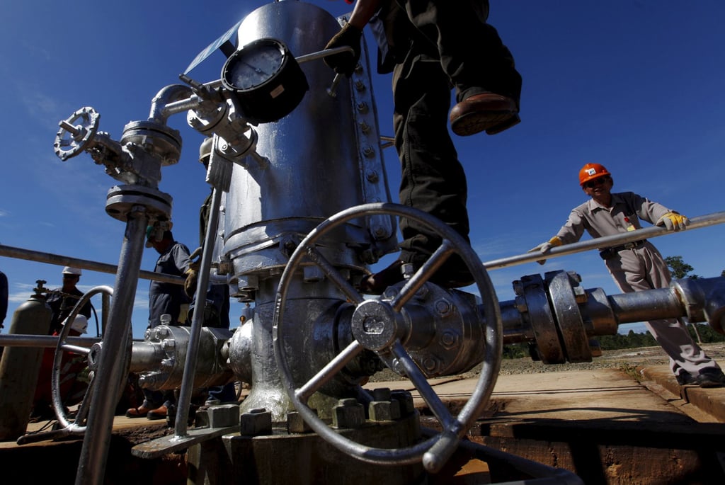 A PT Pertamina worker climbs on a gauge at a crude oil well. Indonesia relies on energy imports, with Singaporean firms frequently taking part in Pertamina’s petrol and crude oil tenders. Photo: Reuters A PT Pertamina worker climbs on a gauge at a crude oil well. Indonesia relies on energy imports, with Singaporean firms frequently taking part in Pertamina’s petrol and crude oil tenders. Photo: Reuters