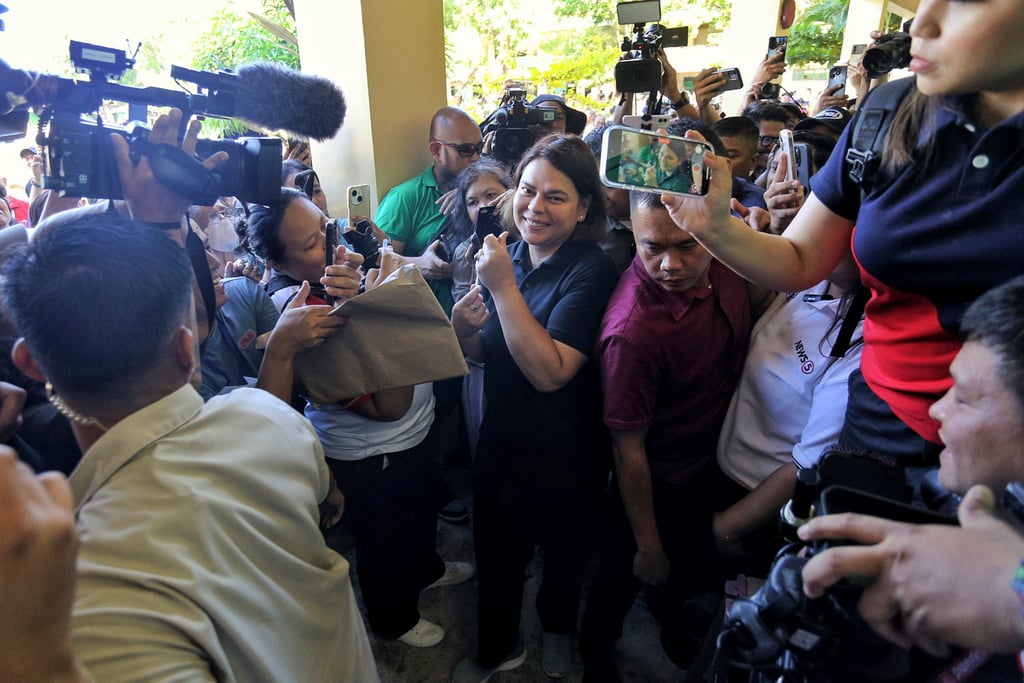 Philippine Vice-President Sara Duterte-Carpio (centre) arrives to cast her vote at a polling centre in Davao City on May 12. Her approval rating rose seven percentage points ahead of the midterm election. Photo: AP Philippine Vice-President Sara Duterte-Carpio (centre) arrives to cast her vote at a polling centre in Davao City on May 12. Her approval rating rose seven percentage points ahead of the midterm election. Photo: AP