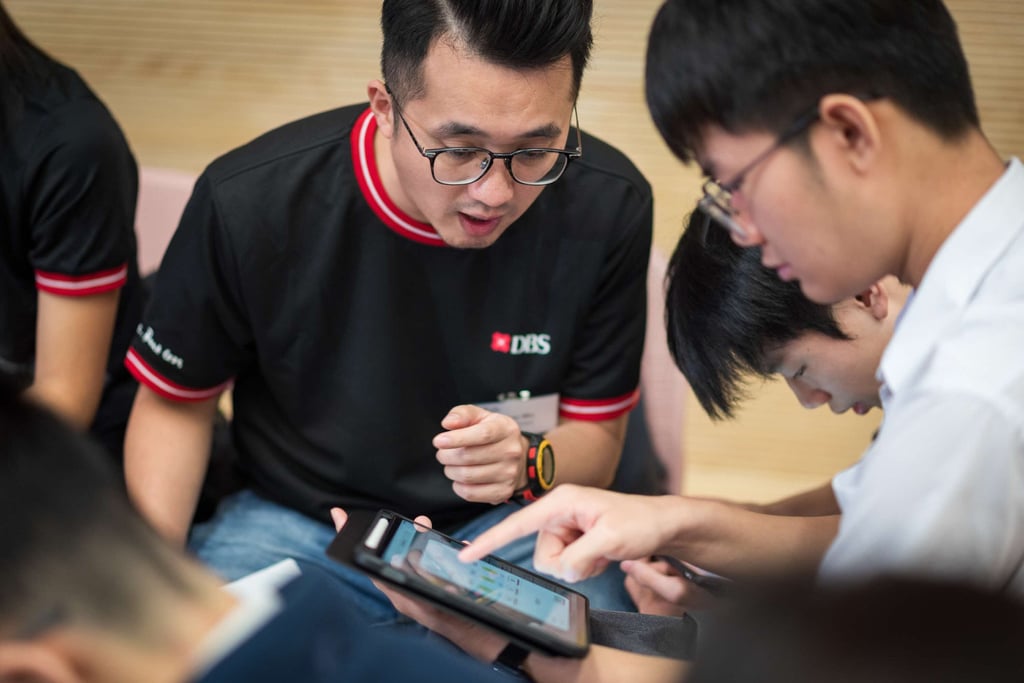 DBS volunteers help students improve their financial knowledge so they can avoid risks, such as scams, as part of a DBS Foundation programme. Photo: DBS.