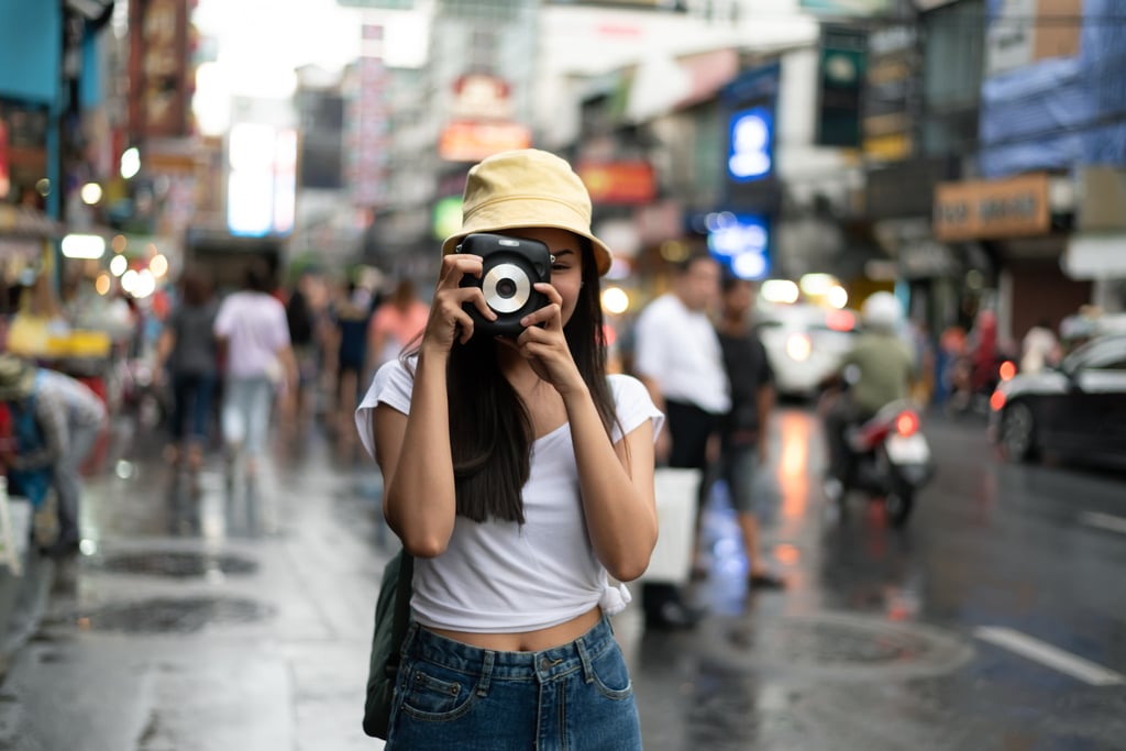 A traveller with an instant camera takes a photo in Thailand. Photo: Shutterstock A traveller with an instant camera takes a photo in Thailand. Photo: Shutterstock
