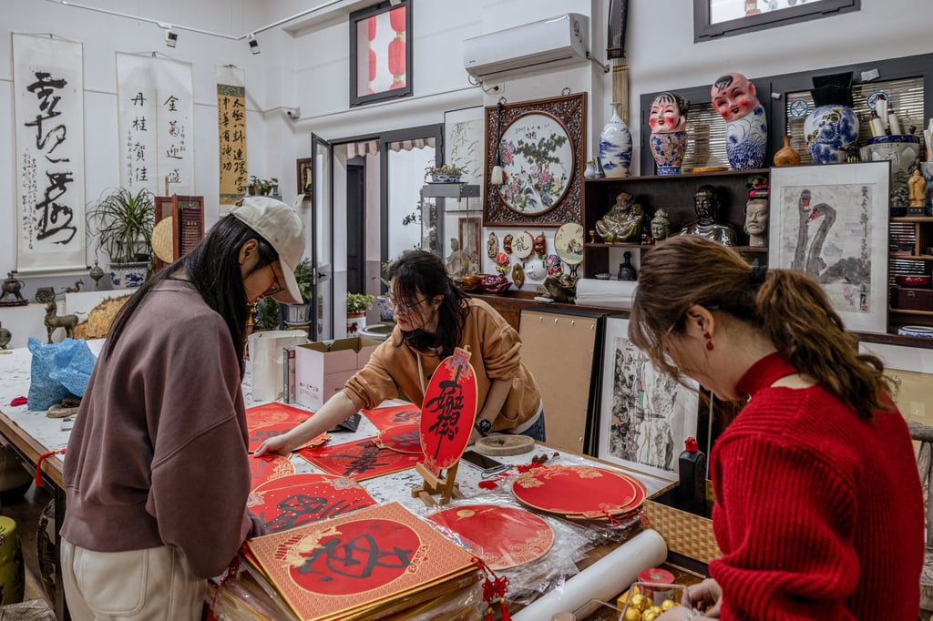 Members of Centro Culturale Cinese on Via Paolo Sarpi prepare paper signs ahead of Lunar New Year in February 2024. Photo: Getty Images