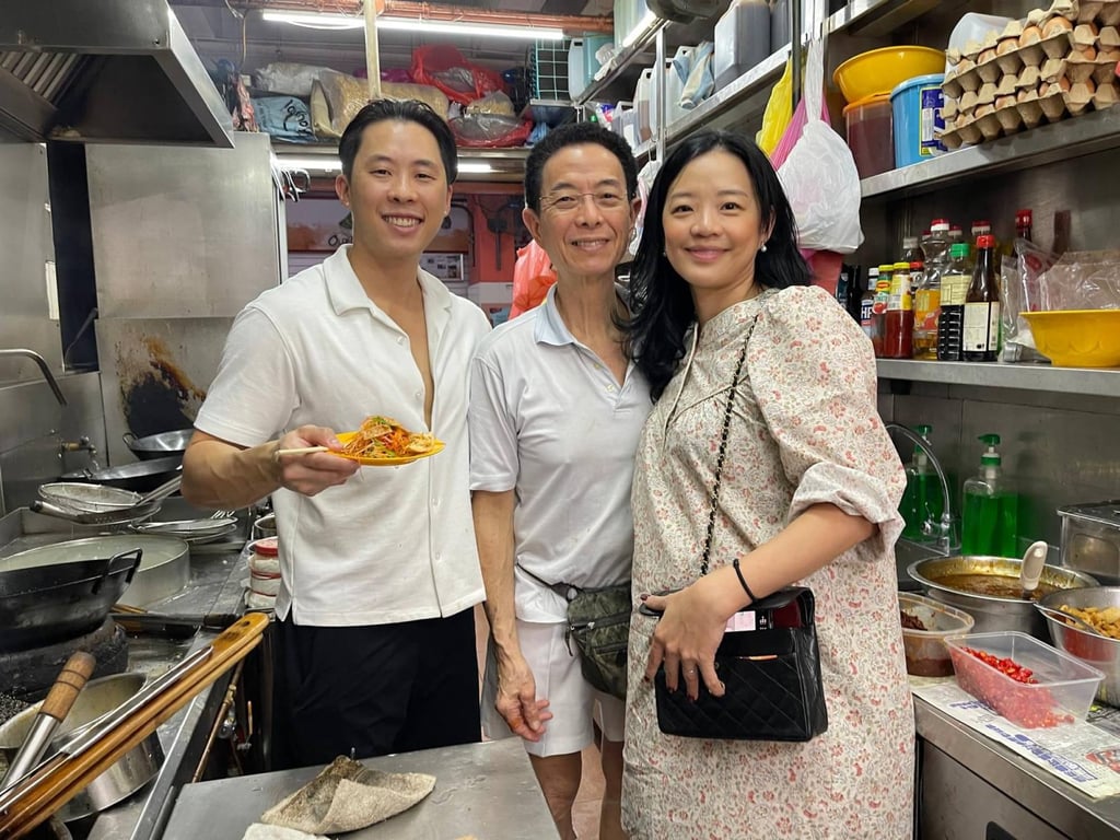 Ngo in the stall’s kitchen with his father and sister in 2025. Photo: Ngo Xing Jun