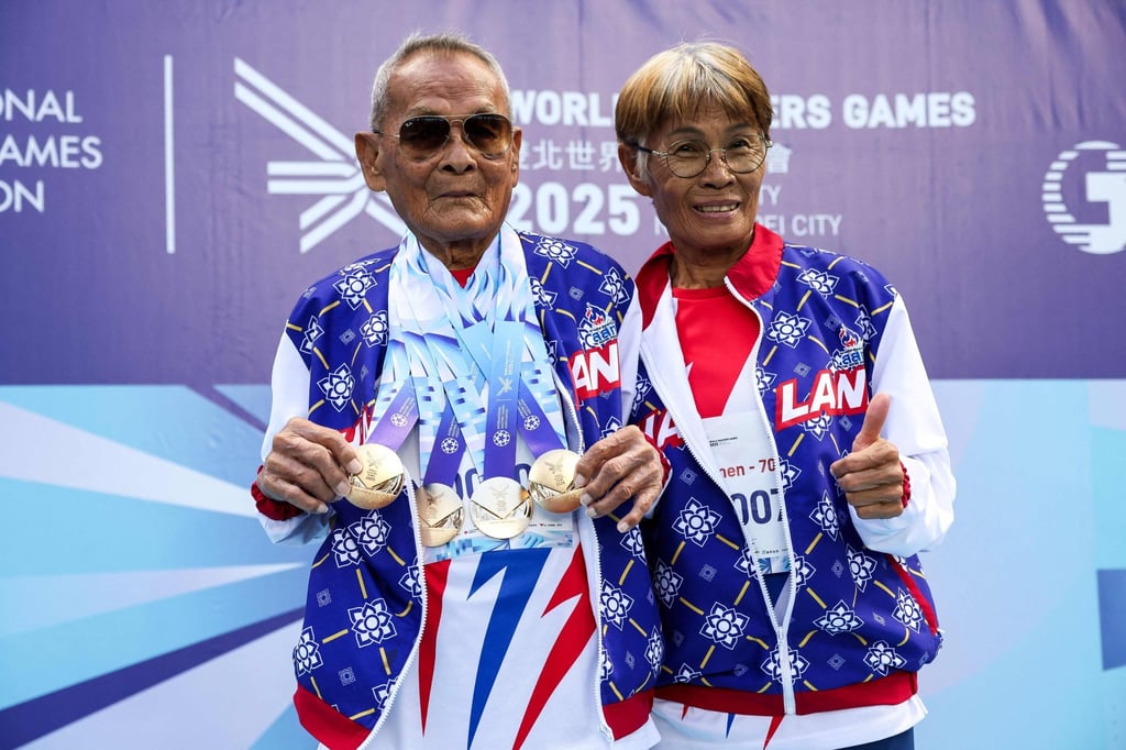 Thailand’s Sawang Janpram (left) with his daughter Siripan Janpram after winning gold in the men’s shot. Photo: AFP