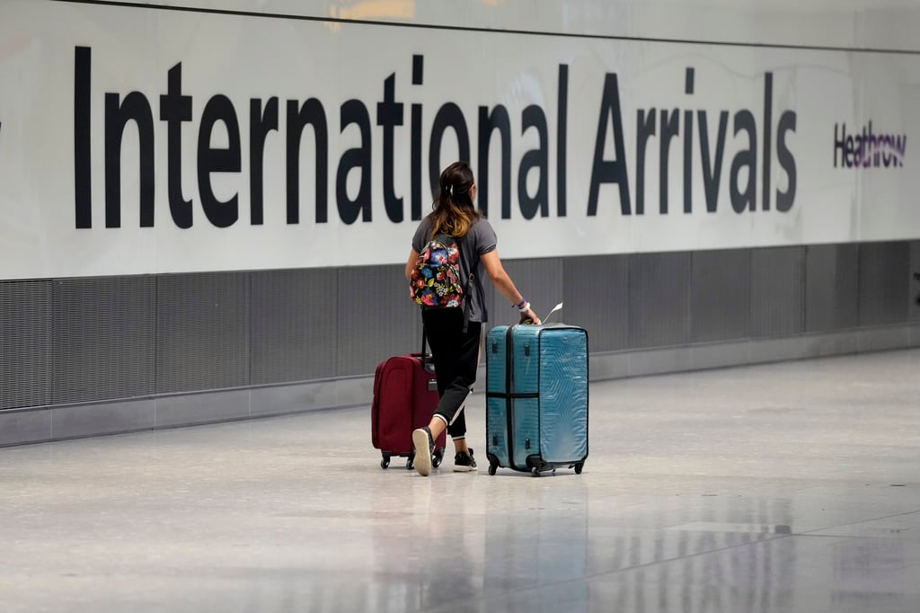A passenger arrives after disembarking from a flight at Heathrow Airport in London. Photo: AP A passenger arrives after disembarking from a flight at Heathrow Airport in London. Photo: AP