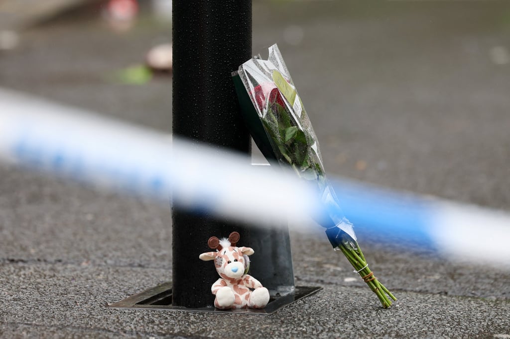 Tributes lie on the ground near the site of the incident. Photo: Reuters Tributes lie on the ground near the site of the incident. Photo: Reuters