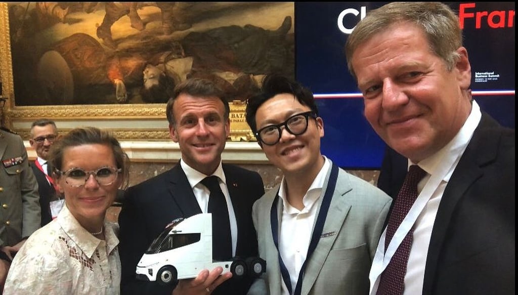 French President Emmanuel Macron (centre) holds a model of an electric lorry made by Windrose, a Chinese company founded by entrepreneur Wen Han (right), at the Choose France summit in Versailles, France on Monday. Photo: Instagram/whan6023 French President Emmanuel Macron (centre) holds a model of an electric lorry made by Windrose, a Chinese company founded by entrepreneur Wen Han (right), at the Choose France summit in Versailles, France on Monday. Photo: Instagram/whan6023