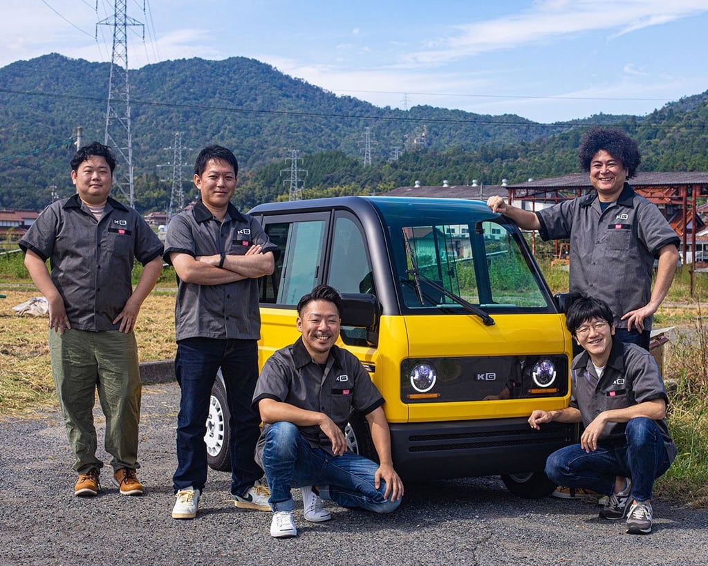KG Motors’ CEO Kazunari Kusunoki (second left) and his team with the battery-powered minibot. Photo: Handout KG Motors’ CEO Kazunari Kusunoki (second left) and his team with the battery-powered minibot. Photo: Handout