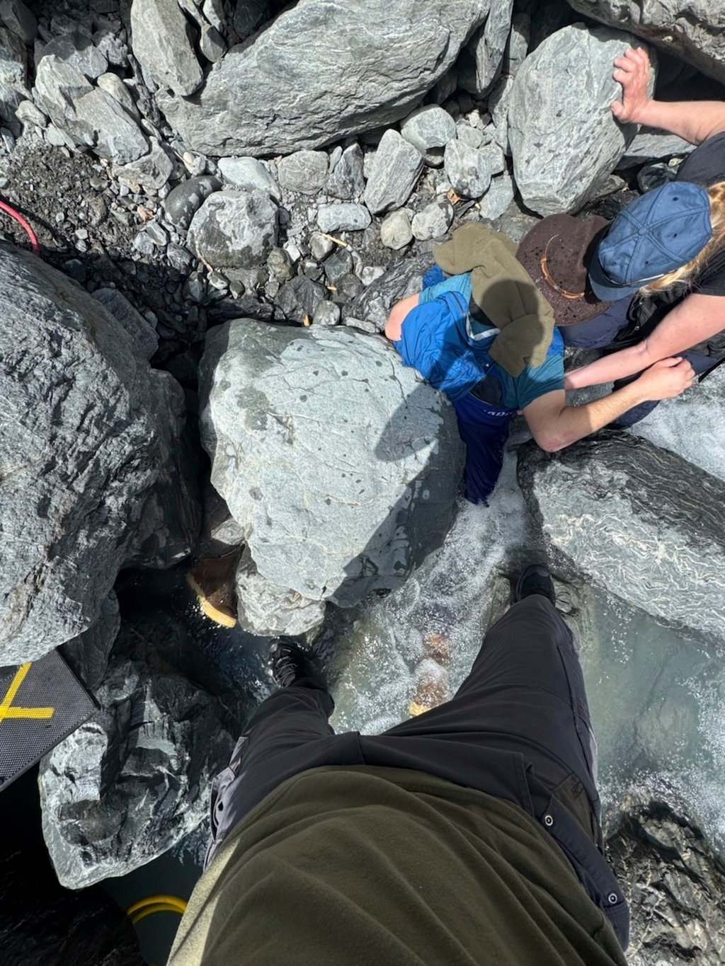 Kell Morris, upper right in a brown hat, trapped under a boulder. Photo: Jason Harrington/Seward Fire Department via AP Kell Morris, upper right in a brown hat, trapped under a boulder. Photo: Jason Harrington/Seward Fire Department via AP