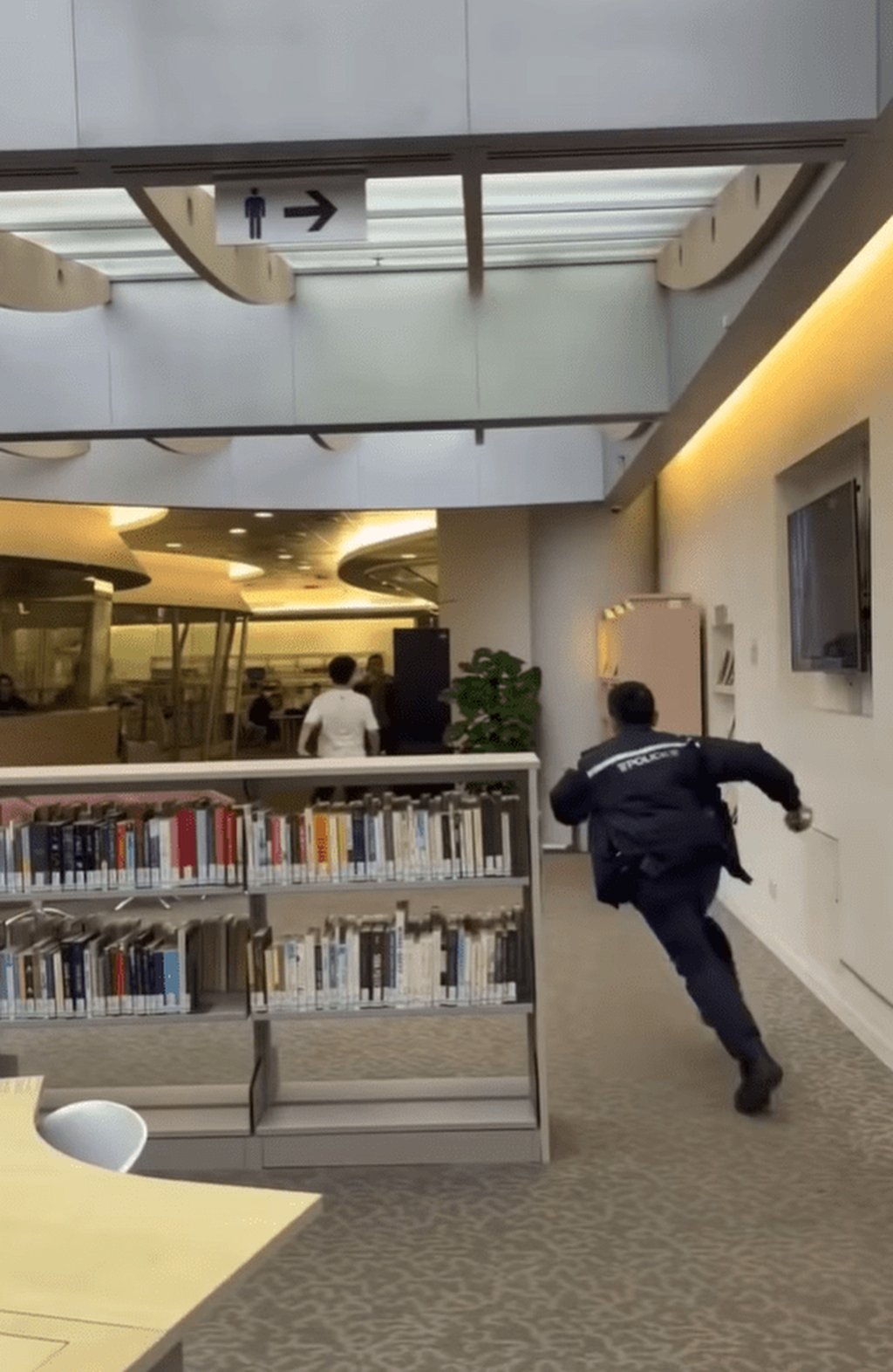 A screengrab from a video shows police chasing the defendant (white shirt) after he attacked several people at the City University campus. Photo: Handout A screengrab from a video shows police chasing the defendant (white shirt) after he attacked several people at the City University campus. Photo: Handout