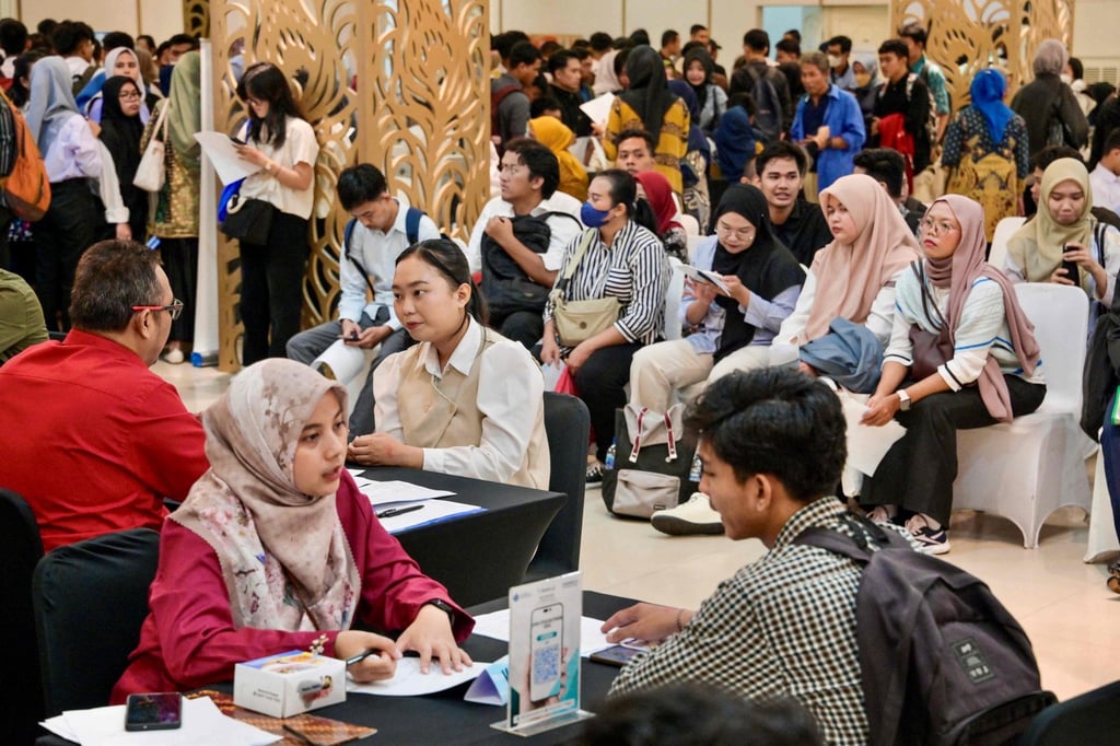 Jobseekers consult officers from the department of manpower during a job fair in Jakarta on May 22. Photo: AFP Jobseekers consult officers from the department of manpower during a job fair in Jakarta on May 22. Photo: AFP