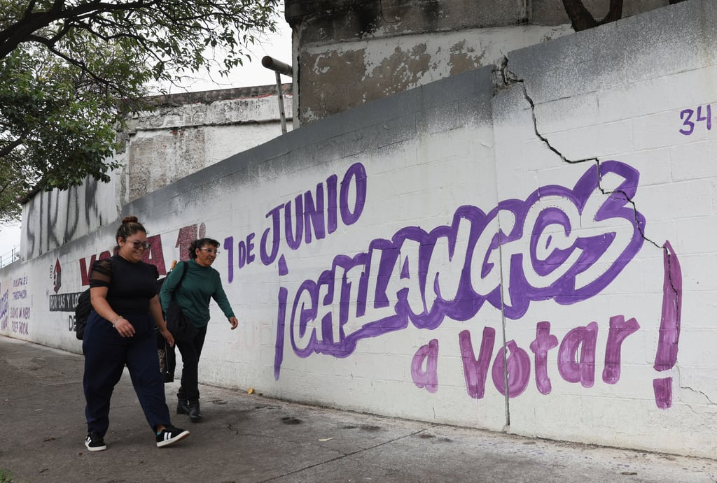 Women walk past electoral propaganda messages painted on a wall encouraging people to vote, ahead of the judicial and magistrate election, in Mexico City. Photo: Reuters Women walk past electoral propaganda messages painted on a wall encouraging people to vote, ahead of the judicial and magistrate election, in Mexico City. Photo: Reuters