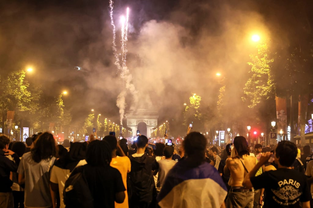 PSG supporters celebrate on the Champs-Elysees. Photo: AP