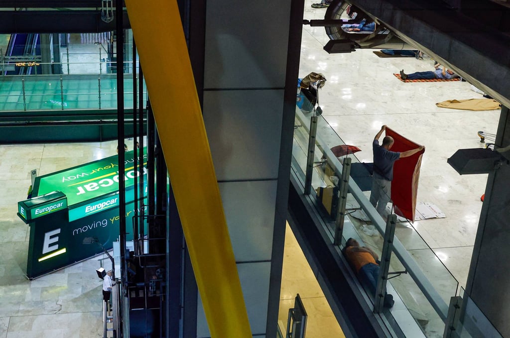 Homeless people lay on the floor of Terminal 4 of the Adolfo Suárez Madrid-Barajas airport in Madrid. Photo: AFP Homeless people lay on the floor of Terminal 4 of the Adolfo Suárez Madrid-Barajas airport in Madrid. Photo: AFP