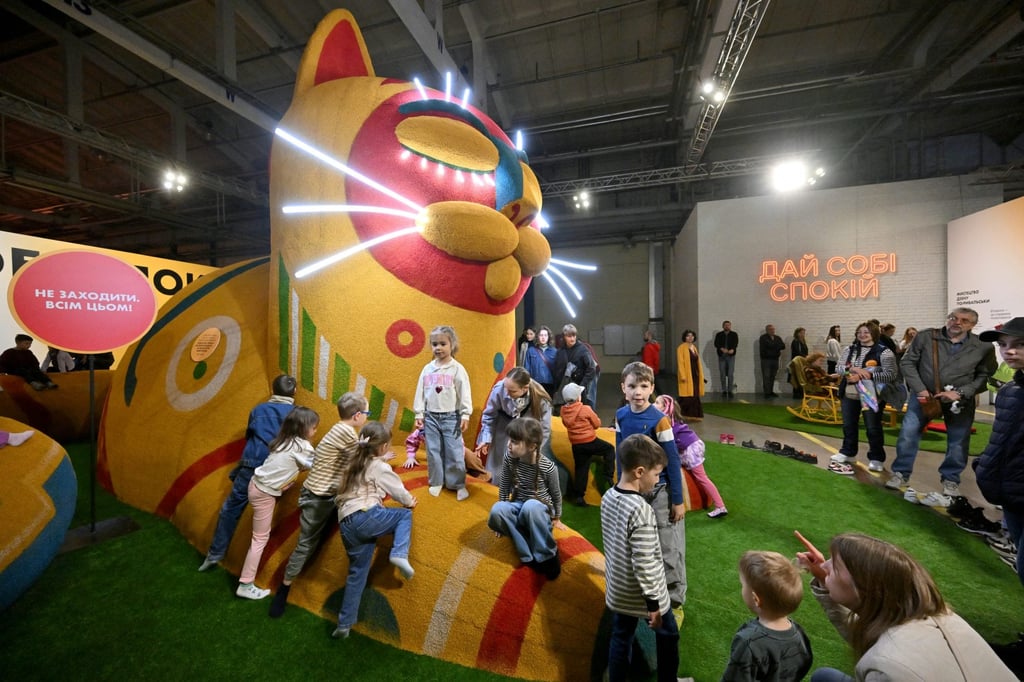 Children play on an installation at the “Third Wind” exhibition. Photo: AFP
