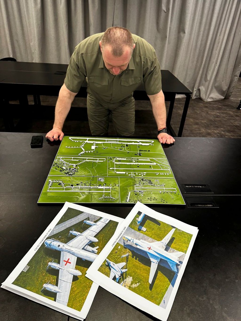 The head of the Ukrainian security services, Vasyl Malyuk, studying pictures and a map of Russia’s strategic aviation. Photo: SBU via EPA-EFE