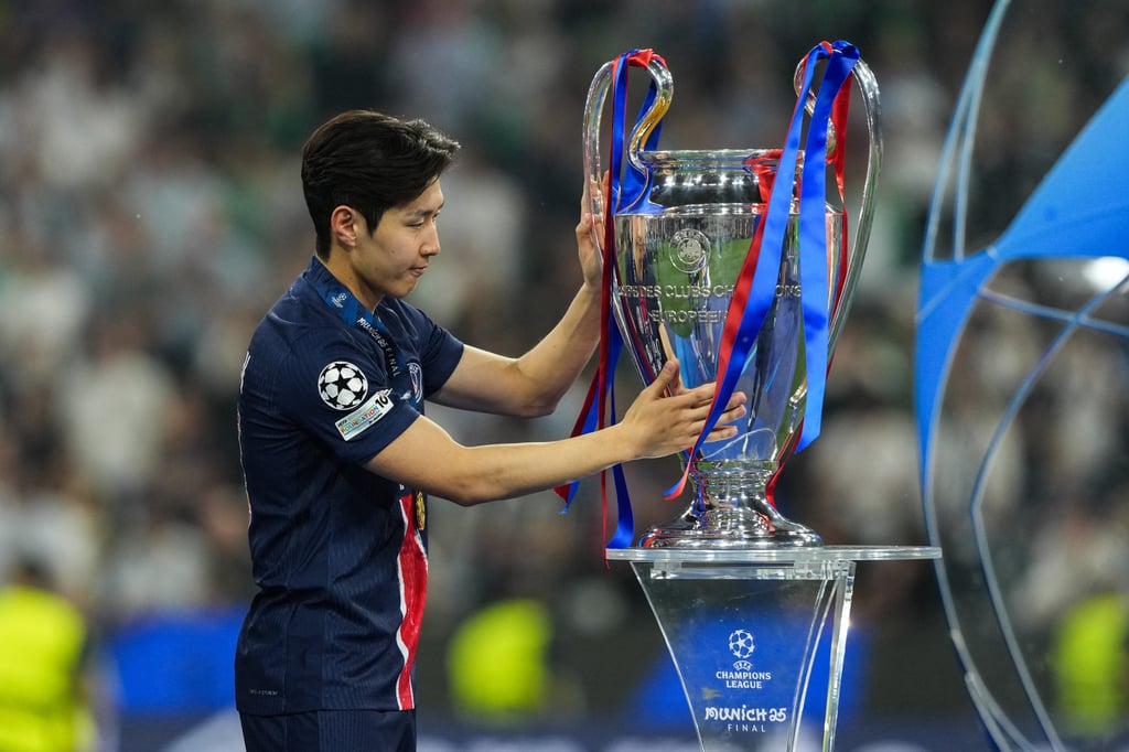 Paris Saint-Germain’s Lee Kang-in touches the Champions League trophy. Photo: Xinhua