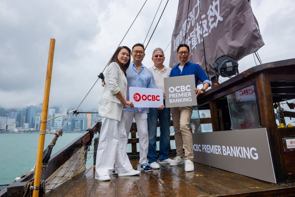 OCBC executives celebrate the success of its Singapore and Hong Kong twin-hub strategy on board the Dukling in Victoria Harbour.