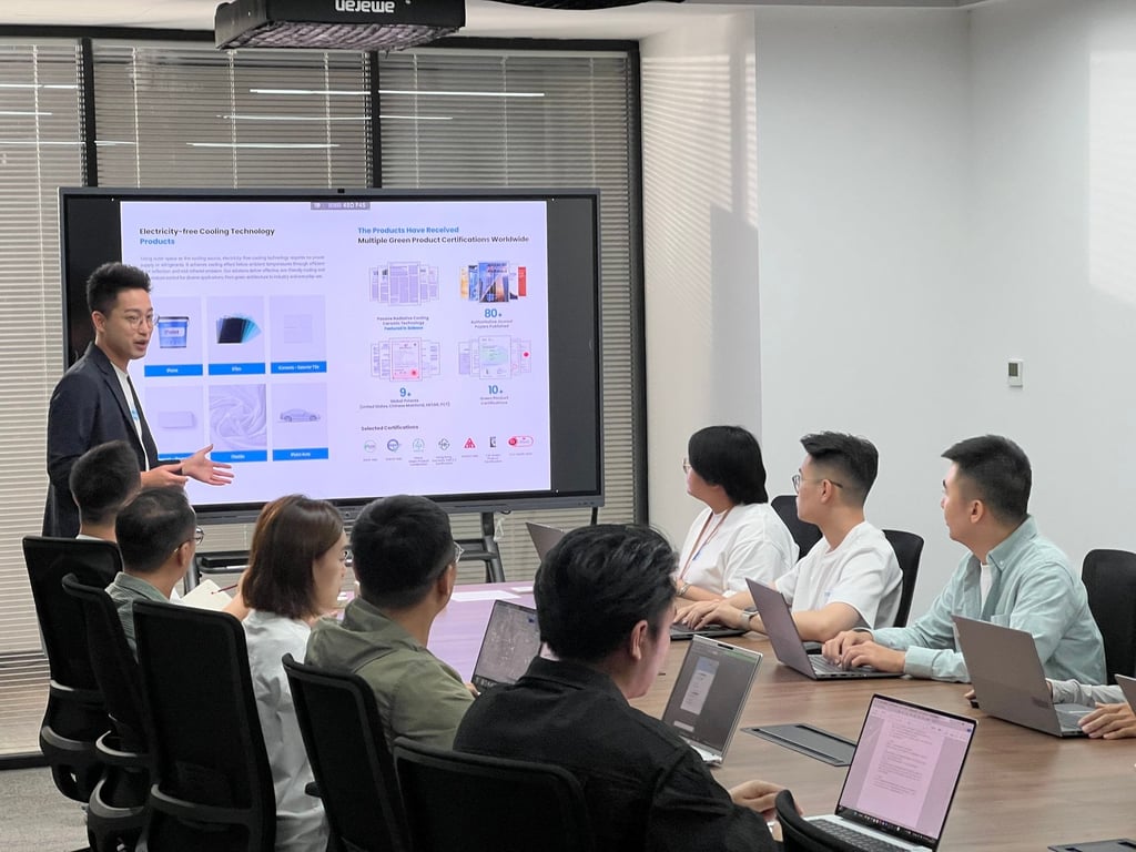 Martin Zhu (standing) conducts a training session on i2Cool’s electricity-free cooling product range with his staff.