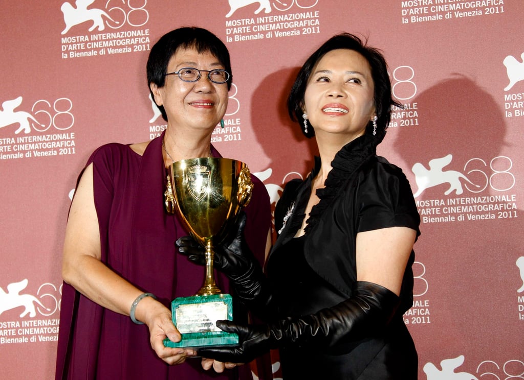 Ann Hui, director of A Simple Life, poses with Deanie Ip as Ip holds the best actress trophy awarded for her role in the film at the 2011 Venice International Film Festival. Photo: AP