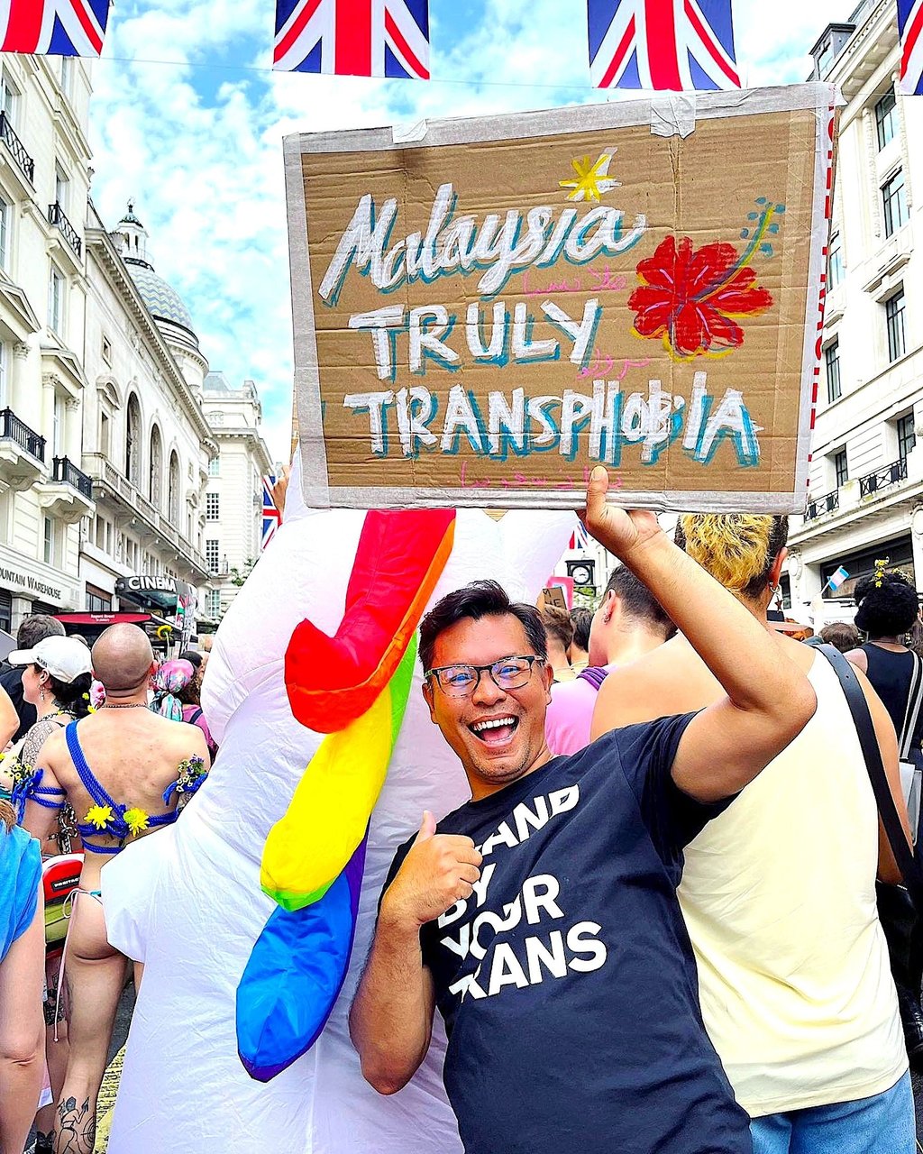 Warren Hallett at a Pride event in the UK with a placard that plays on a Malaysian tourism promotion slogan. Photo: Warren Hallett
