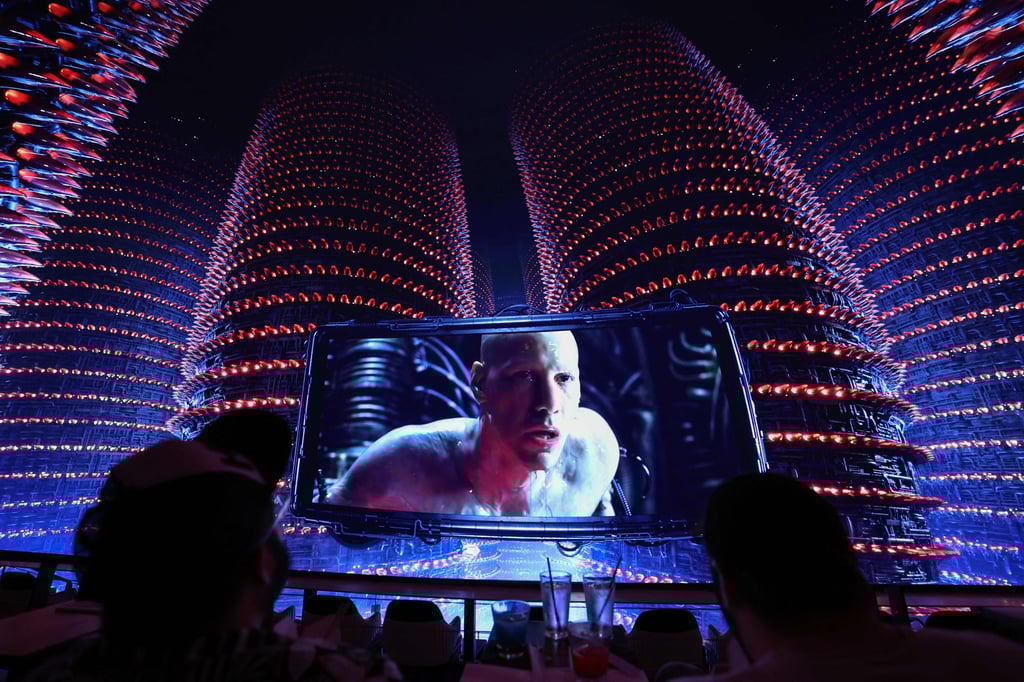Neo (Keanu Reeves) appears on screen with an extended display of the power plant towers during the first “shared reality” screening of the movie The Matrix on an immersive dome screen inside Cosm Los Angeles. Photo: AFP