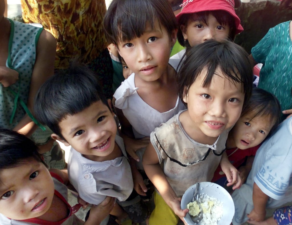 A group of Vietnamese children gather around a photographer. Photo: AP A group of Vietnamese children gather around a photographer. Photo: AP