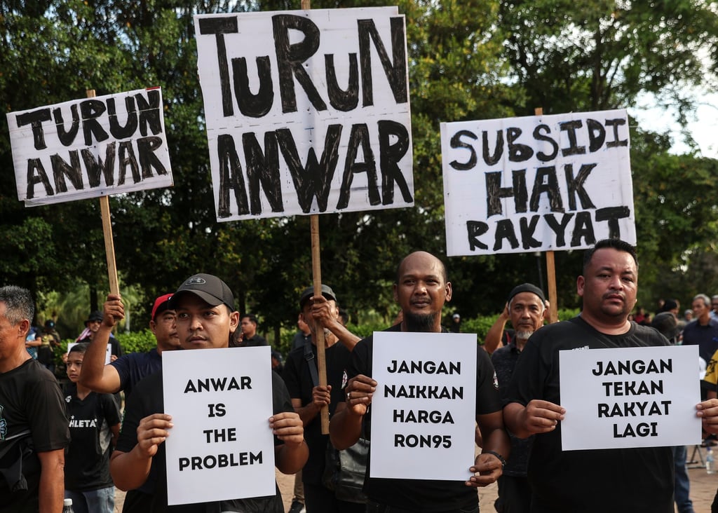 Protesters hold placards outside Malaysian Prime Minister Anwar Ibrahim’s official residence in June last year in a demonstration against subsidy cuts. Photo: EPA-EFE Protesters hold placards outside Malaysian Prime Minister Anwar Ibrahim’s official residence in June last year in a demonstration against subsidy cuts. Photo: EPA-EFE