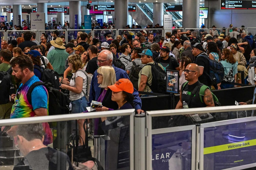 Travellers queue at Miami International Airport. President Donald Trump signed a new travel ban on June 4, targeting 12 countries. Photo: AFP