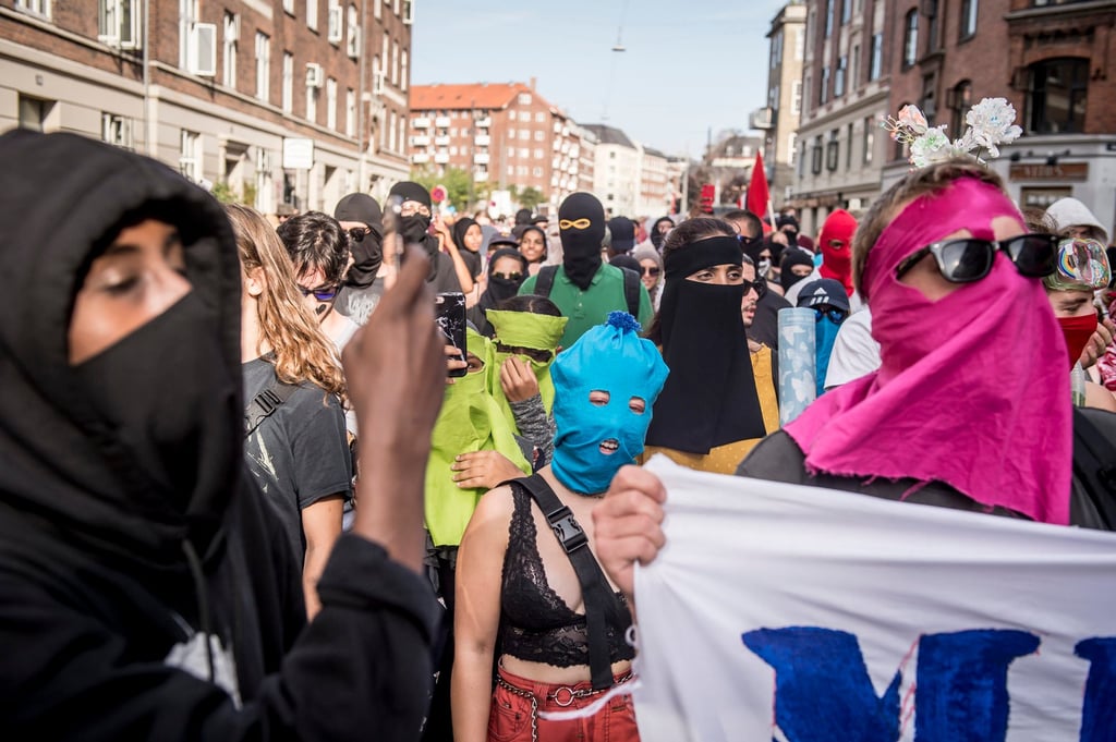 People protest in Copenhagen in 2018, as the new ban on garments covering the face is implemented. Photo: via AP
