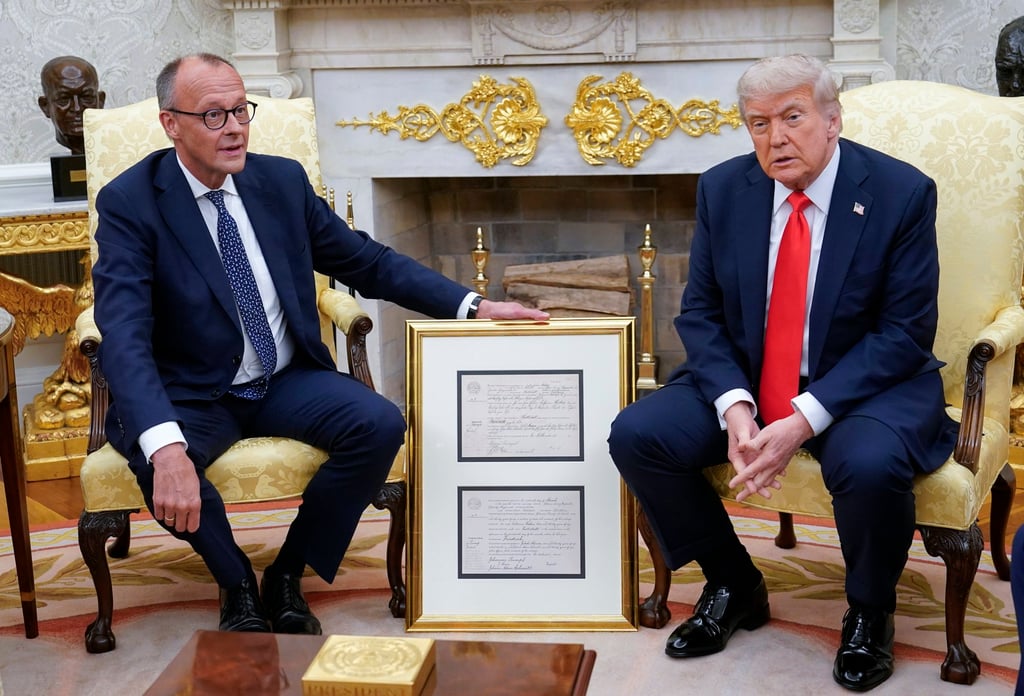 German Chancellor Friedrich Merz (left) presents US President Donald Trump with the birth certificate of Trump’s grandfather, as they meet at the Oval Office on Thursday. Photo: EPA-EFE German Chancellor Friedrich Merz (left) presents US President Donald Trump with the birth certificate of Trump’s grandfather, as they meet at the Oval Office on Thursday. Photo: EPA-EFE