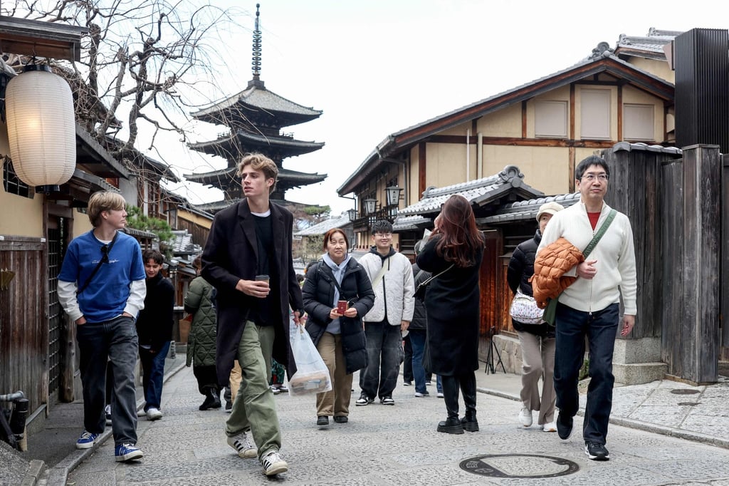 Tourists walk through the streets of Higashiyama, a historic neighbourhood in eastern Kyoto. Every month, Japan’s cultural capital receives 3 to 4 million visitors. Photo: AFP