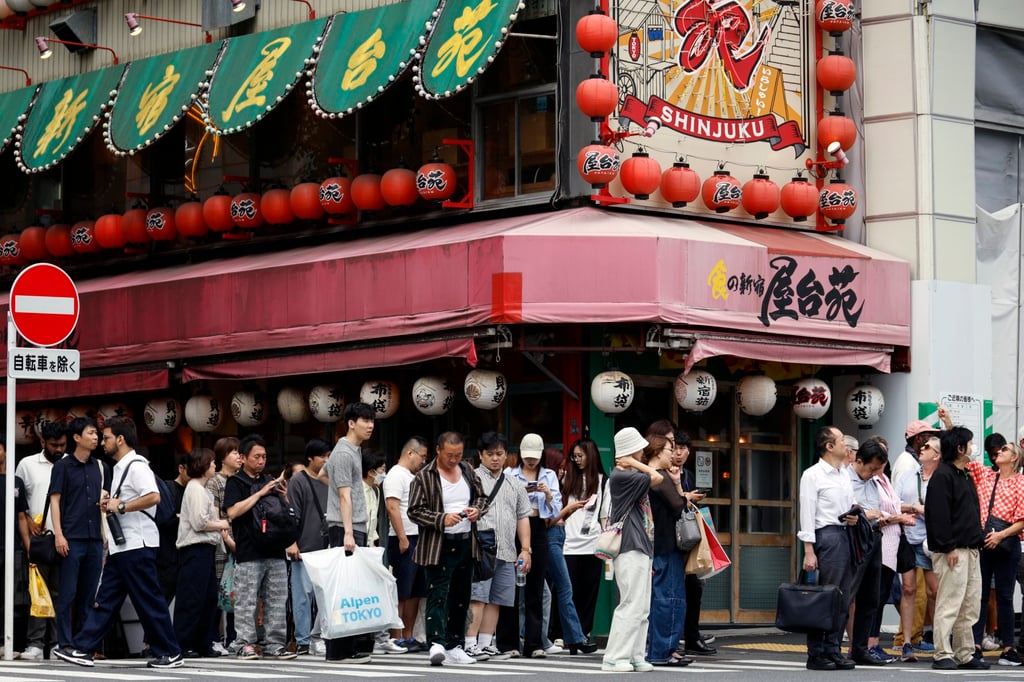 People cross a street in Tokyo’s Shinjuku business and shopping district. Japan’s economy recorded its first economic contraction in four quarters. Photo: EPA-EFE