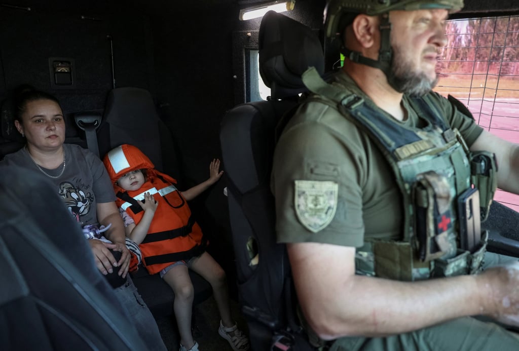 Milana, aged four, and her mother Olesya sit in an armoured vehicle as police evacuate them, amid Russia’s attack on Ukraine, in the frontline town of Kostyantynivka, in the Donetsk region, on Saturday. Photo: Reuters