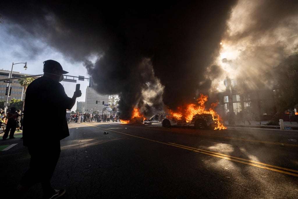 Waymo cars set on fire as protesters clash with law enforcement. Photo: AFP