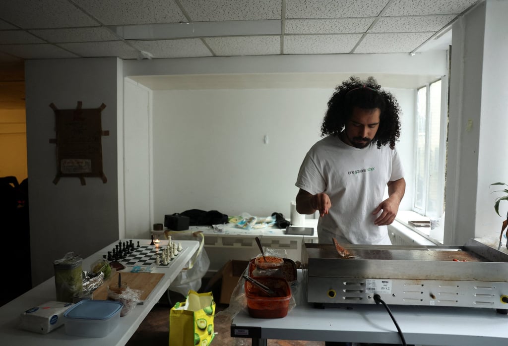 Manu Marmolejo, from north London, cooks some Mexican tacos during a session at the Knight Club, a diverse chess club based in London that has grown to almost 1,000 members in a year. Photo: Reuters