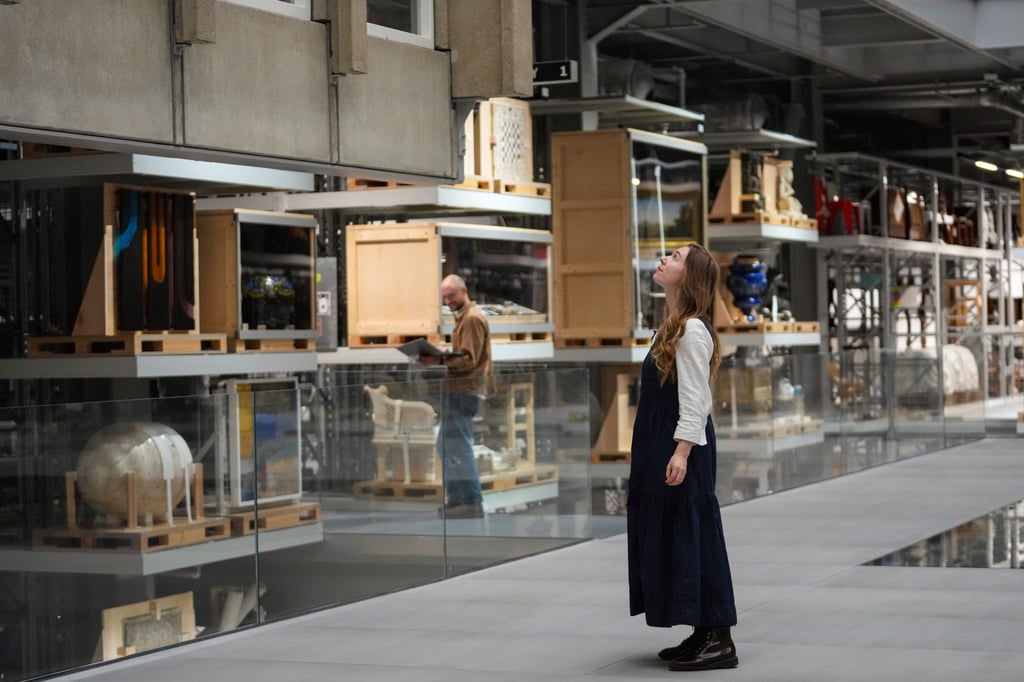 V&A East Storehouse senior curator Georgia Haseldine among some of the thousands of items on display at the new London venue. Photo: AP