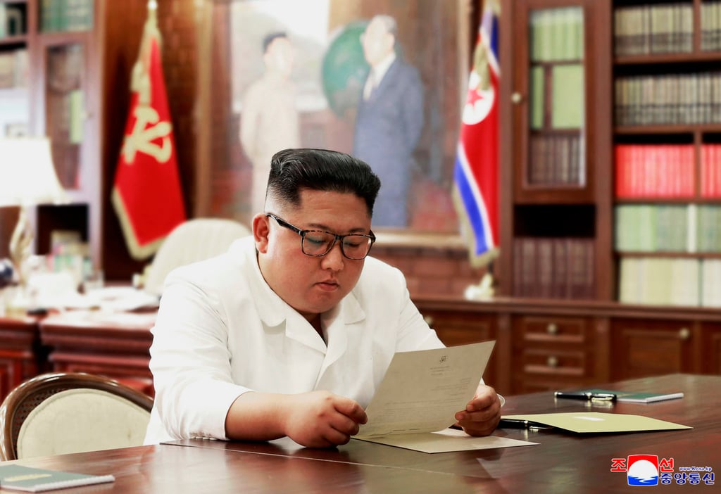 North Korean leader Kim Jong-un reads a letter from US President Donald Trump in June 2019. Photo: KCNA/KNA/AFP