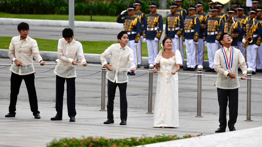 Marcos (right) and his family lead Independence Day flag-raising and wreath-laying rites at the Jose Rizal monument on Thursday. Photo: EPA-EFE Marcos (right) and his family lead Independence Day flag-raising and wreath-laying rites at the Jose Rizal monument on Thursday. Photo: EPA-EFE