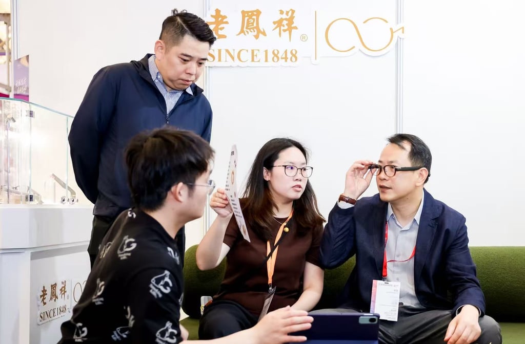 Lao Feng Xiang chairman Yang Yi, right, tries on a pair of the company’s new line of smart glasses powered by ByteDance’s artificial intelligence technology. Photo: Handout Lao Feng Xiang chairman Yang Yi, right, tries on a pair of the company’s new line of smart glasses powered by ByteDance’s artificial intelligence technology. Photo: Handout