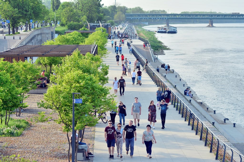 People walk along the Vistula River promenade in Warsaw. Photo: Shutterstock