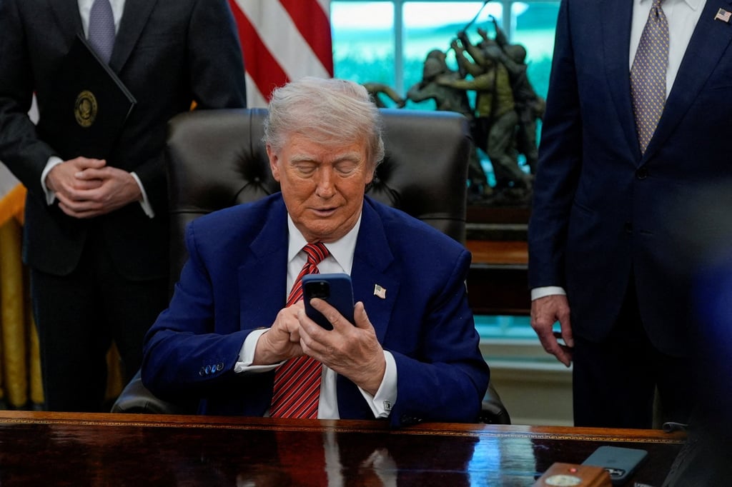 US President Donald Trump holds an iPhone after it rang while he was speaking at the White House on May 23. Photo: Reuters US President Donald Trump holds an iPhone after it rang while he was speaking at the White House on May 23. Photo: Reuters