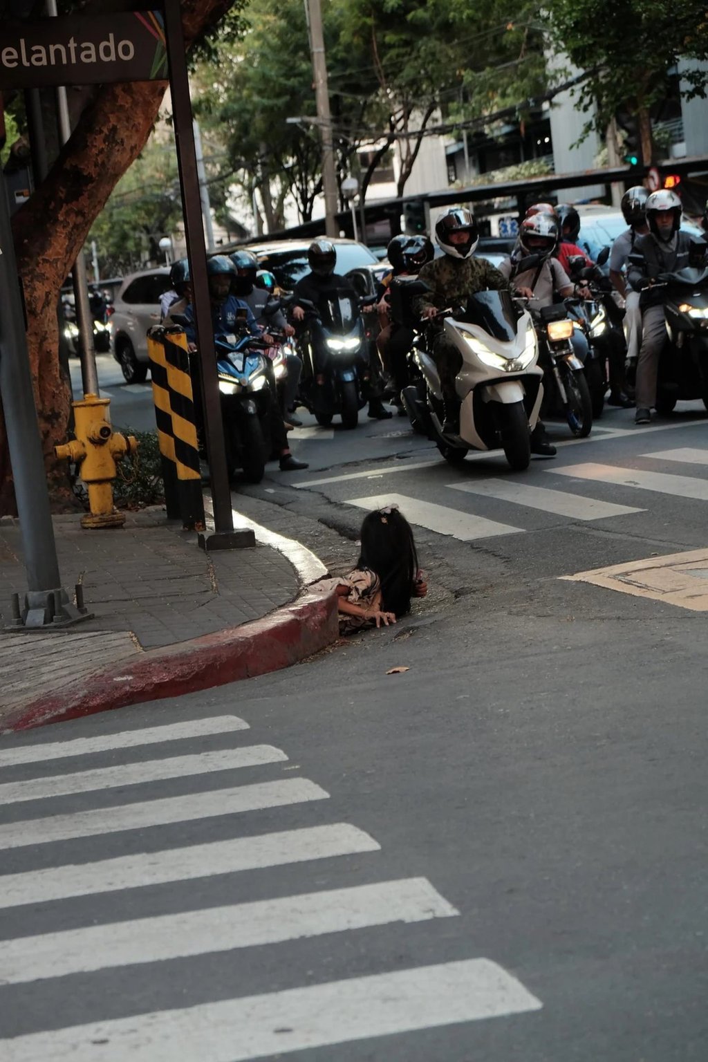 A woman is photographed emerging from a drainage hole along a street in Makati City. There are about 4.5 million homeless individuals in the Philippines, according to a 2023 study. Photo: William Roberts A woman is photographed emerging from a drainage hole along a street in Makati City. There are about 4.5 million homeless individuals in the Philippines, according to a 2023 study. Photo: William Roberts
